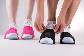 Close-up of The DanceSocks over sneakers on a smooth dance floor