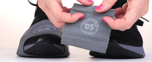 Close-up of The DanceSocks being put on a sneaker, showing premium USA-made quality